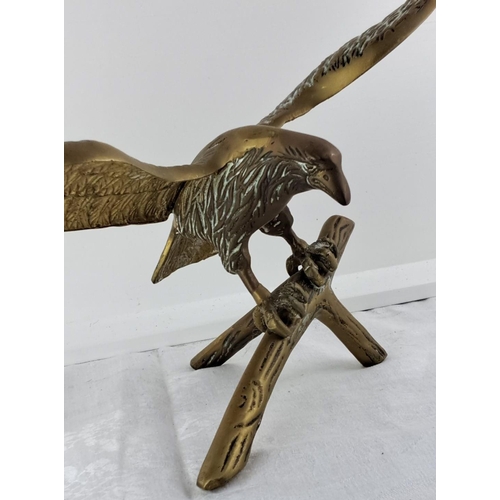 63 - large Brass eagle sculpture with wings outstretched, perched on a branch. Exquisite detailing on fea... 