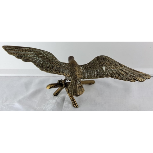 63 - large Brass eagle sculpture with wings outstretched, perched on a branch. Exquisite detailing on fea... 