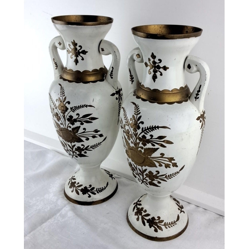 65 - Pair of vintage white enamel vases featuring gold floral motifs and dual handles with intricate gold... 