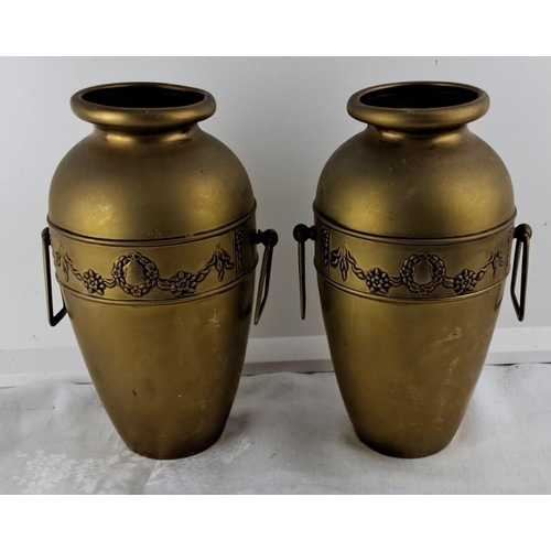 67 - Pair of antique brass vases with ornate floral wreath and garland design, featuring side handles.