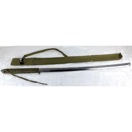 73 - Military-style sword with green woven fabric handle and scabbard, featuring decorative knotting on t... 