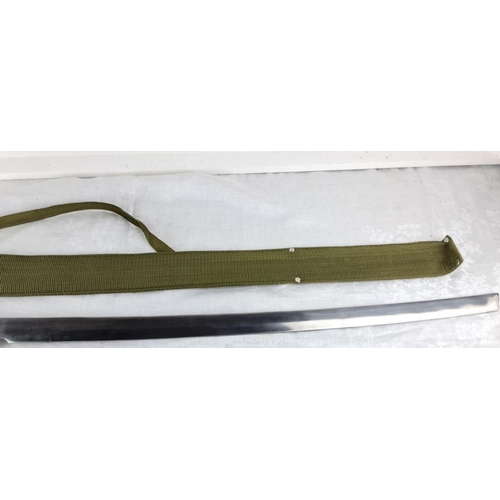 73 - Military-style sword with green woven fabric handle and scabbard, featuring decorative knotting on t... 