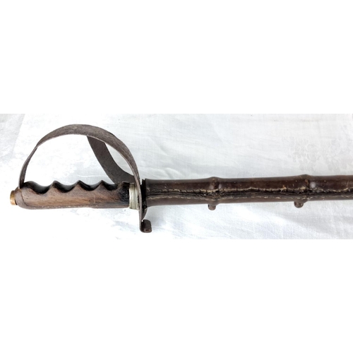 74 - Antique leather-bound cavalry sword hilt featuring a detailed wooden grip and protective metal knuck... 