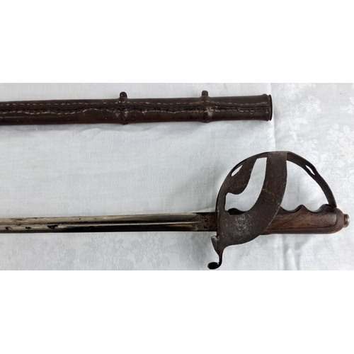 74 - Antique leather-bound cavalry sword hilt featuring a detailed wooden grip and protective metal knuck... 