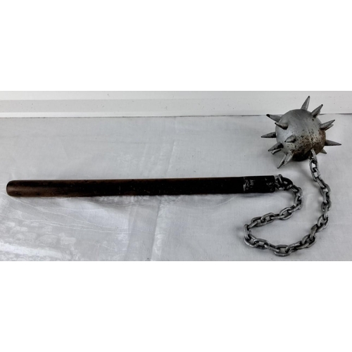 75 - Replica medieval flail with wooden handle, metal chain, and spiked ball.