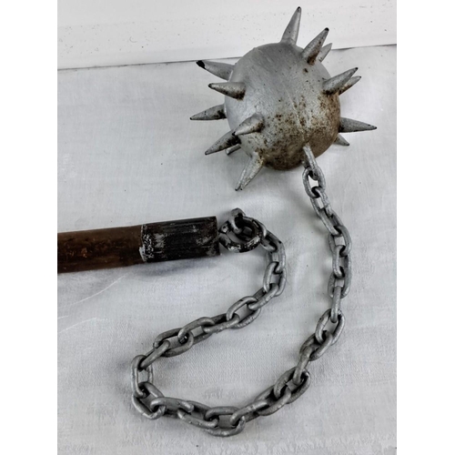 75 - Replica medieval flail with wooden handle, metal chain, and spiked ball.