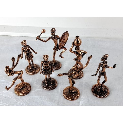 79 - Collection of African tribal dancers figures and a Canadian souvenir bell.