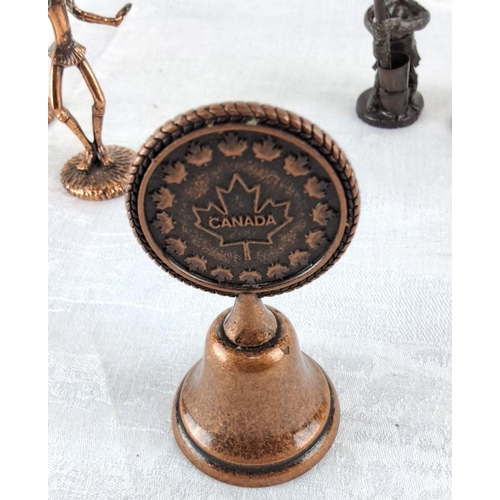 79 - Collection of African tribal dancers figures and a Canadian souvenir bell.