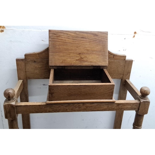 81 - Antique oak umbrella stand from the Edwardian period. It features spindle columns, carved crest, and... 