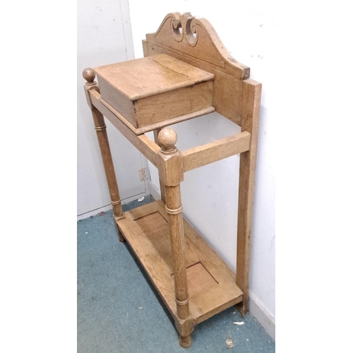 81 - Antique oak umbrella stand from the Edwardian period. It features spindle columns, carved crest, and... 