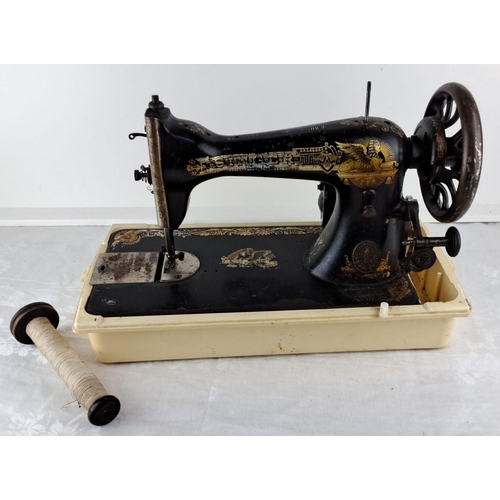 83 - Antique Singer hand-crank sewing machine with Egyptian motifs, from the early 20th century. Black ca... 