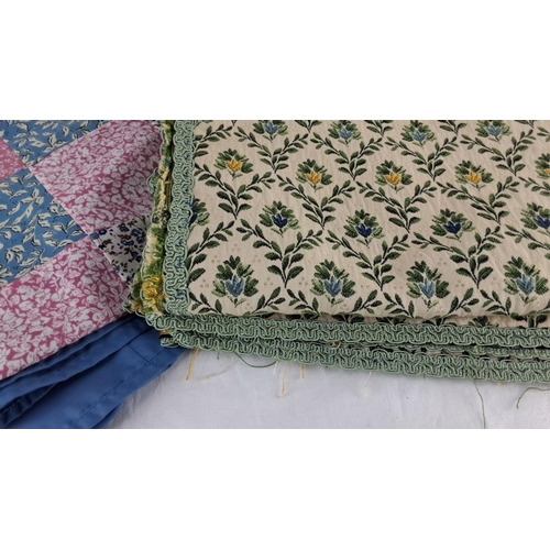 576 - Set of two fabric pieces: a blue and patchwork quilt, and a floral tapestry with green trim.