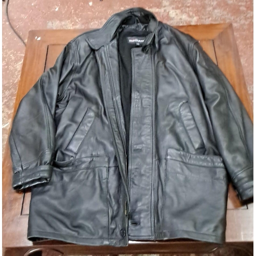 581 - Black jacket, GB size 32. Features double external pockets and a zip-up front.