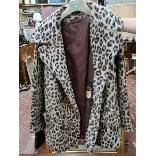 587 - Elmoor of London leopard print faux fur coat features a classic double-breasted design and notched l... 