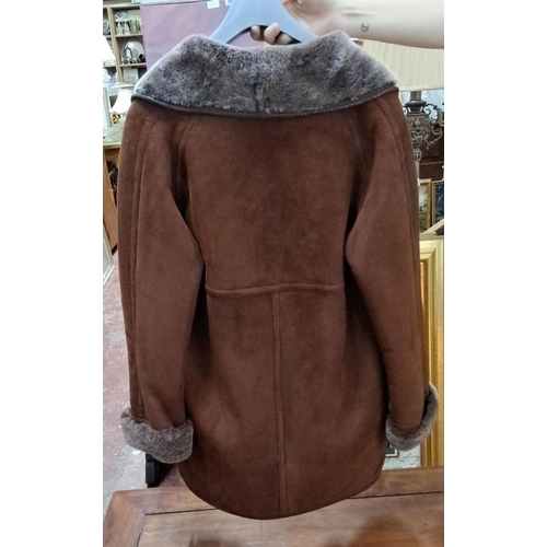 591 - Vintage Sheepskin coat with brown exterior and grey fluffs, featuring foldable cuffs, side pockets, ... 