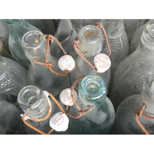 22 - A large collection of vintage glass bottles to include Coca Cola, Madden's Derry.