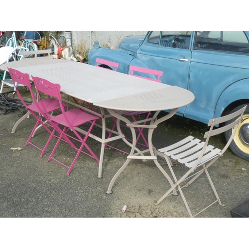 3 - A large garden table with two end leaves and a set of six chairs.