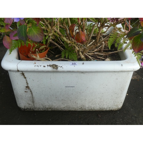 33 - A large vintage ceramic Twyford's Belfast sink with plant (a/f).