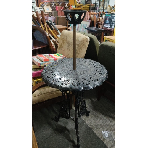 540 - Unusual cast iron table with central oil lamp bracket.  Measuring 112x52x52cm.