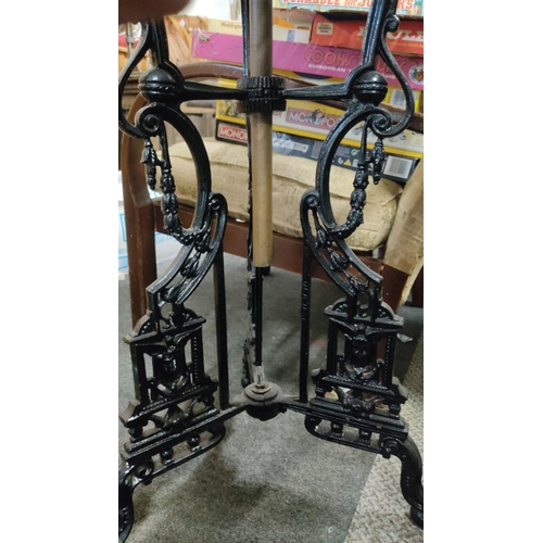 540 - Unusual cast iron table with central oil lamp bracket.  Measuring 112x52x52cm.