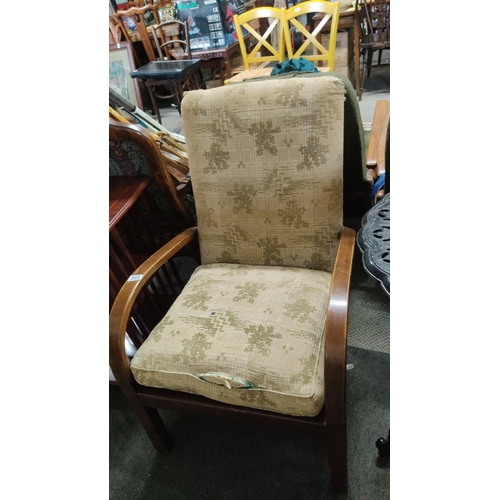 543 - Mid-century modern Parker Knoll armchair with cushioned backrest and seat, wooden armrests, and eart... 