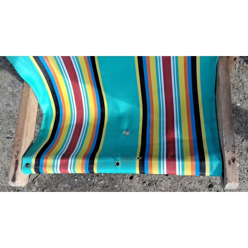 12 - Vintage wooden deck chair with vibrant, multicolored striped canvas seat. Folds for easy storage.