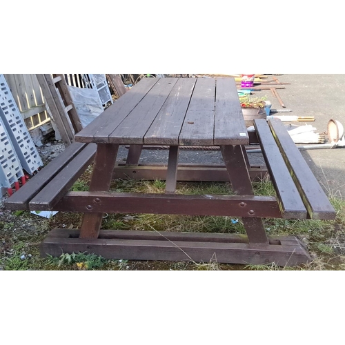 16 - Outdoor wooden picnic table with integrated benches, constructed from sturdy timber in a dark brown ... 