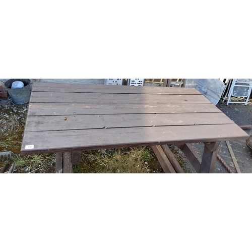 16 - Outdoor wooden picnic table with integrated benches, constructed from sturdy timber in a dark brown ... 