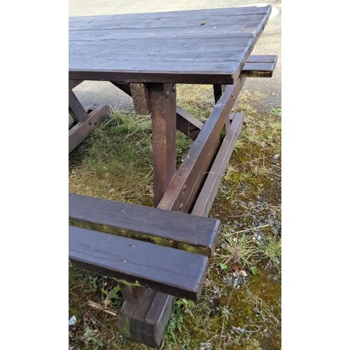 16 - Outdoor wooden picnic table with integrated benches, constructed from sturdy timber in a dark brown ... 