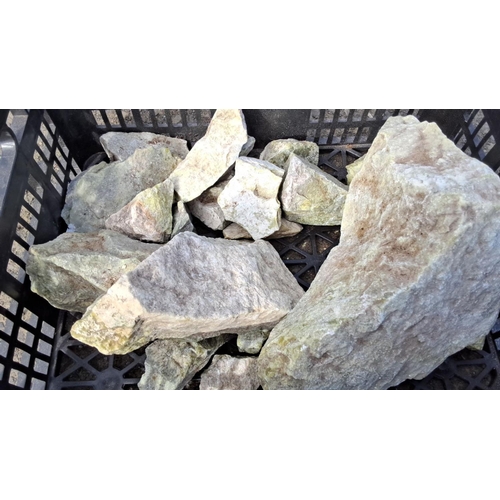 18 - Mixed lot of rough stones in a black crate, various sizes and shapes.