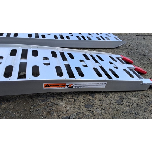 21 - Set of two foldable aluminum loading ramps with red plastic tips.