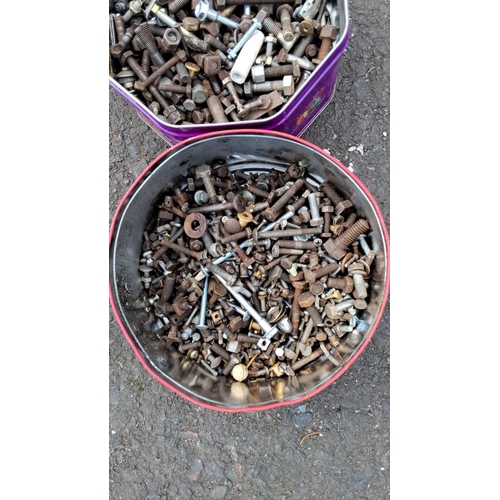 40 - Two metal tins contain mixed bolts, nuts, and assorted hardware items in various sizes and condition... 