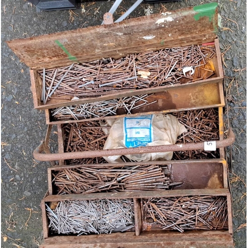 57 - Antique metal toolbox contains assorted nails and fasteners. It features multiple compartments with ... 