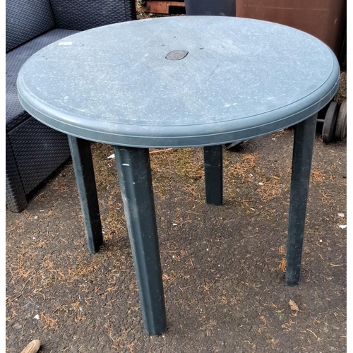 63 - Outdoor round plastic table, green, with four detachable legs and a central hole for an umbrella sta... 