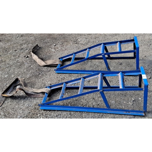 7 - Pair of blue metal car ramps with integrated safety straps.