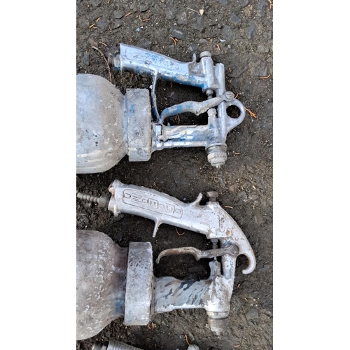 70 - Three vintage paint spray guns, consisting of two DeVilbiss models and one Defendi model.