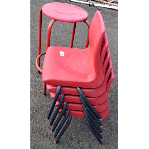 73 - Set of five red child's stacking chairs with black frames and one red metal stool.