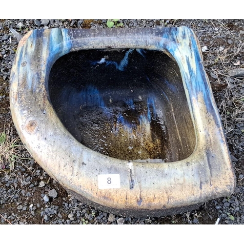 8 - Rustic stone corner trough with weathered patina, rounded edges, and faint blue accents.