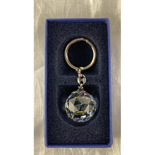 101 - Clear crystal keychain with faceted charm, featuring coloured engravings of 