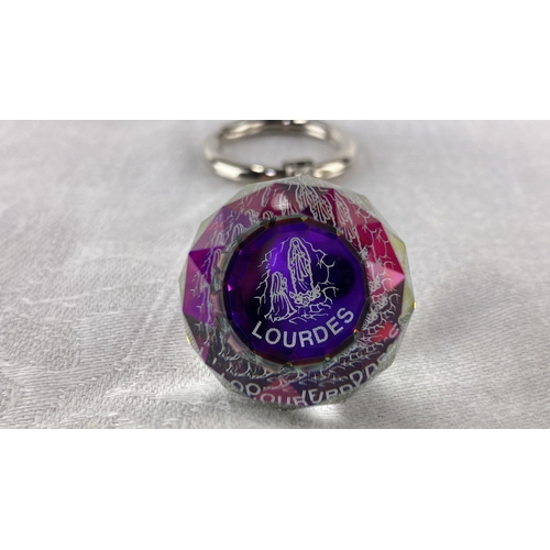 101 - Clear crystal keychain with faceted charm, featuring coloured engravings of 