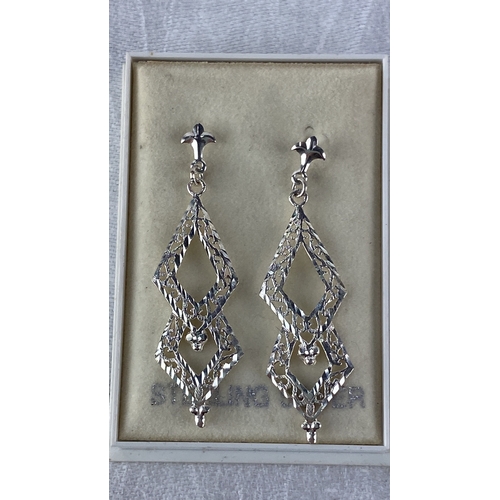 96 - Sterling Silver ornate drop earrings feature intricate filigree design, fleur-de-lis motifs, and dia... 