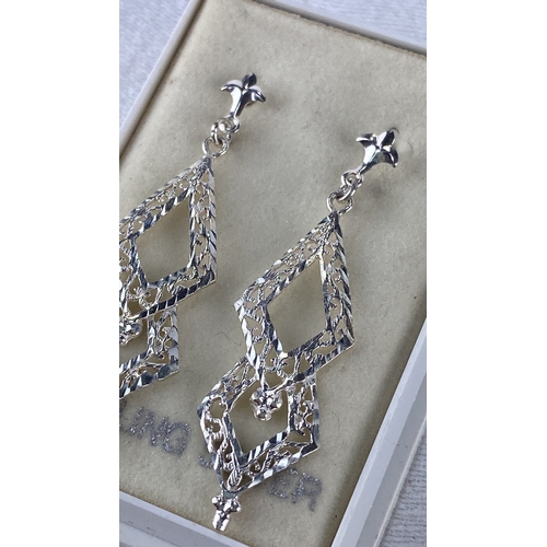 96 - Sterling Silver ornate drop earrings feature intricate filigree design, fleur-de-lis motifs, and dia... 