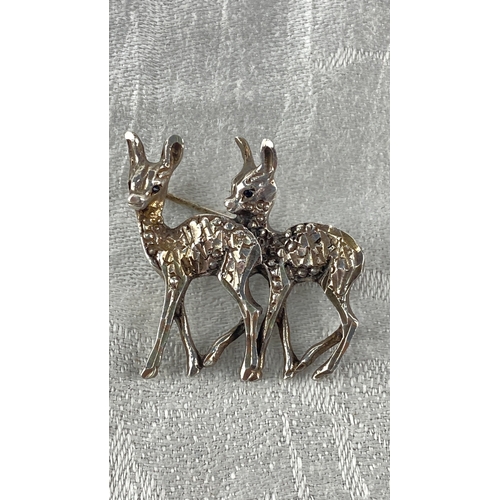 99 - Sterling Silver brooch featuring two stylized deer in a textured design. Marked 