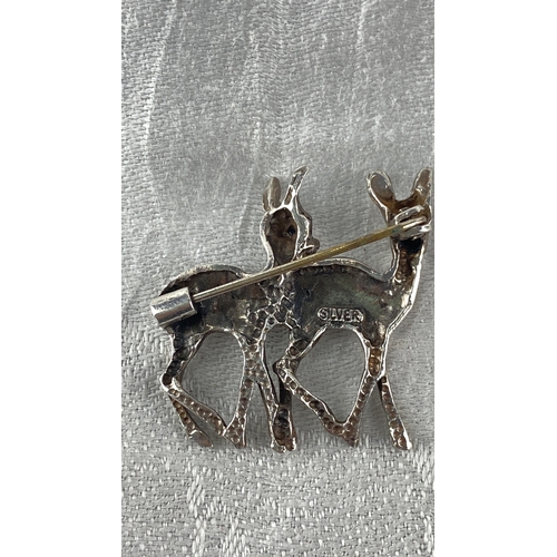 99 - Sterling Silver brooch featuring two stylized deer in a textured design. Marked 