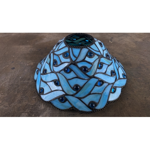 123 - Stained glass lamp shade with intricate blue glass design and embedded blue glass gems, featuring a ... 