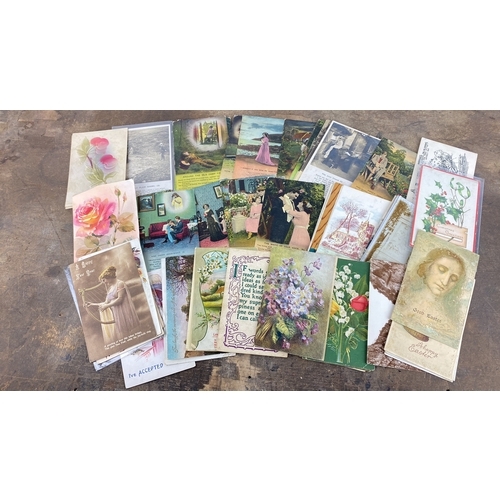 114 - Collection of vintage postcards featuring various themes including florals, landscapes, and sentimen... 