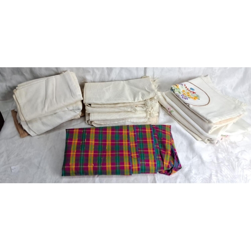 251 - Collection of assorted linens, including white cloths and checked fabric. Includes embroidered table... 