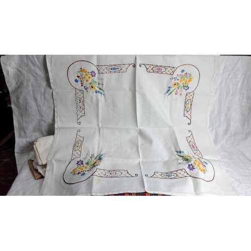 251 - Collection of assorted linens, including white cloths and checked fabric. Includes embroidered table... 