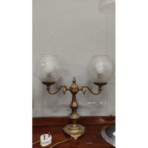 436 - Antique brass table lamp with two frosted glass shades, featuring intricate detailing and ornate des... 