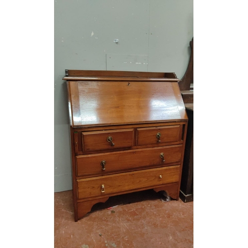 439 - Victorian mahogany drop-front secretary desk with fitted interior compartments and four drawers.